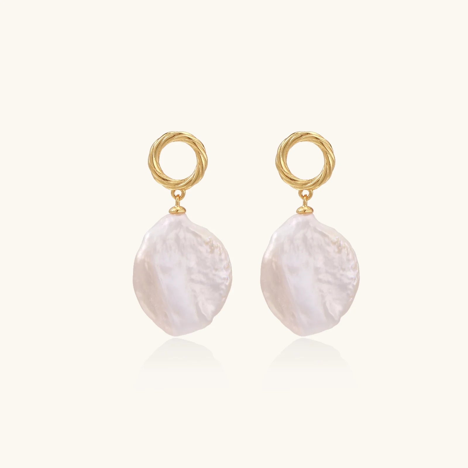 18K gold vermeil twisted circle studs with organic white baroque pearl drops on cream background