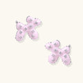 Glossy pink enamel balloon dog stud earrings with crystal details on white gold plated brass, museum-inspired design