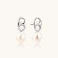 Modern rhodium-plated silver earrings with geometric double-circle design and freshwater pearl drops