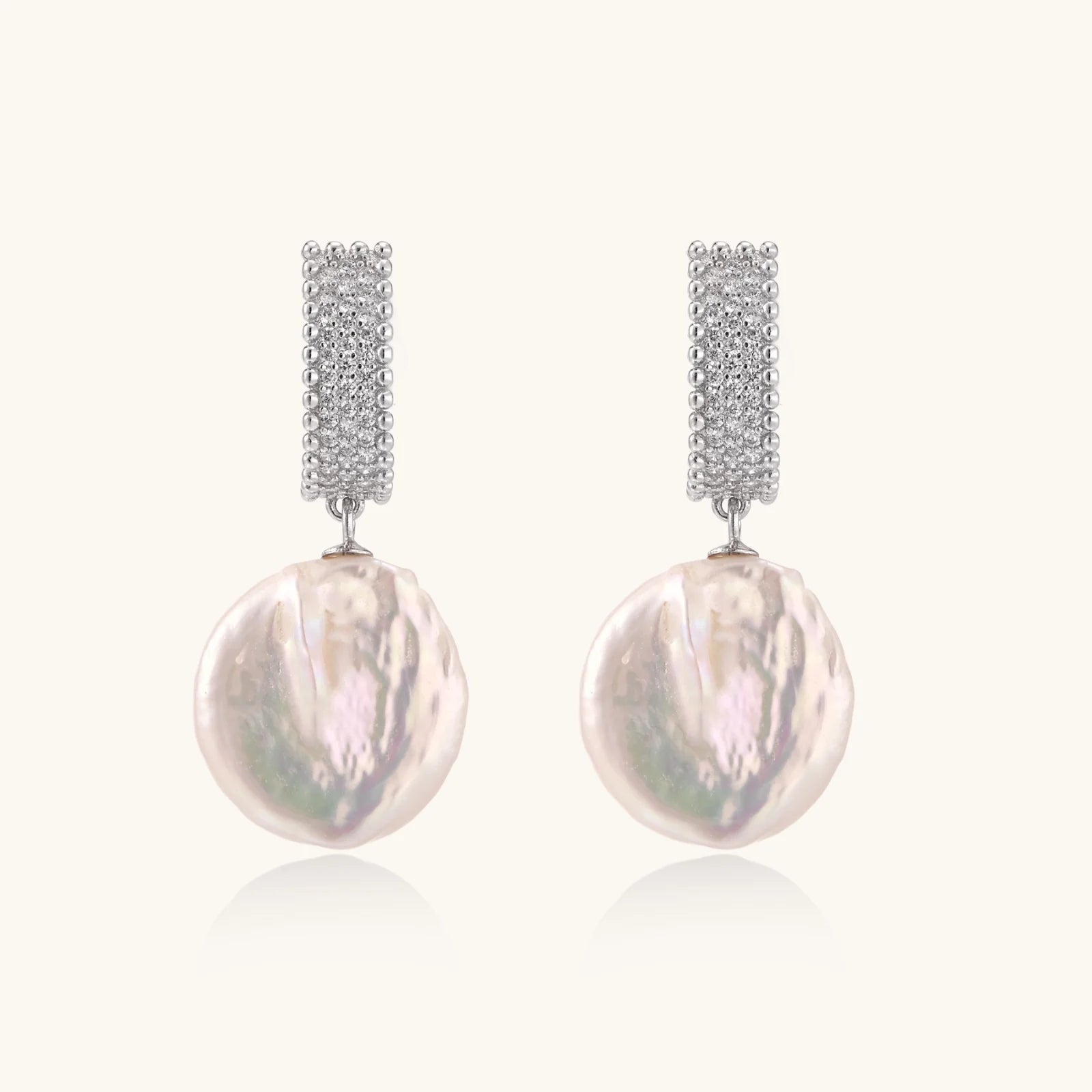 Rhodium-plated silver curved stud with pave stones and baroque pearl drop on white background