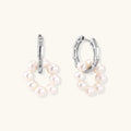 Rhodium-plated silver hoop earrings with freshwater pearls arranged in crescent formation and diamond accents