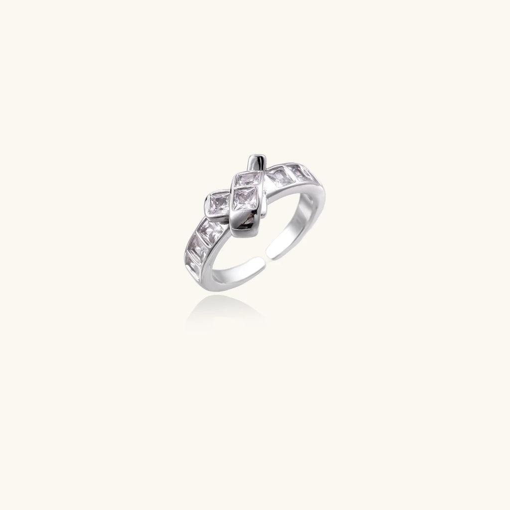 White gold plated adjustable ring featuring offset square cubic zirconia stones in an architectural stacked design