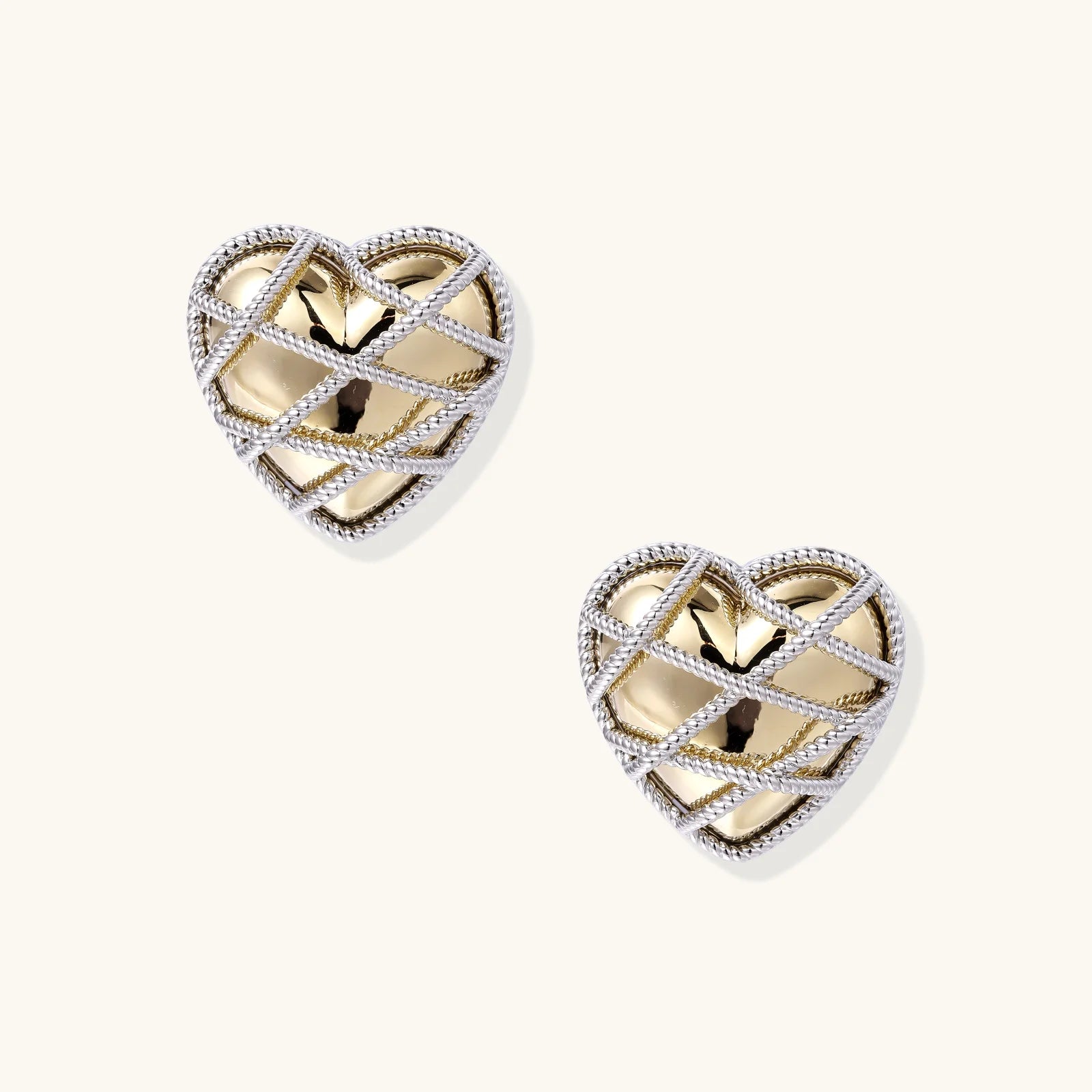 Heart-shaped stud earrings with intricate lattice design in 18K gold plated brass and silver-tone metal.