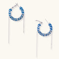 Medium hoop earrings wrapped in blue striped denim fabric with dangling silver chains on white background.