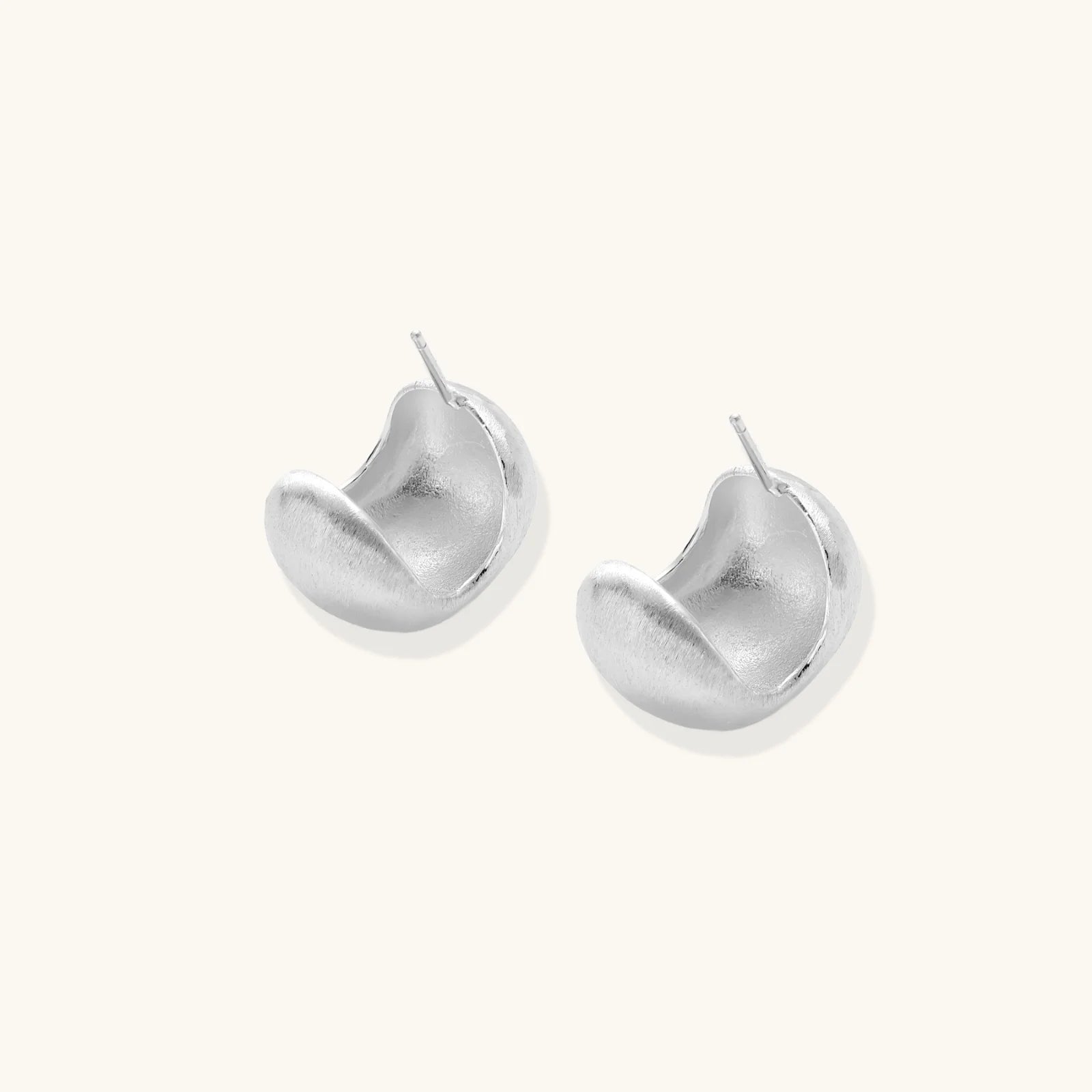 Brushed sterling silver cushion-shaped stud earrings with matte finish on white background