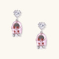 Drop earrings featuring miniature translucent handbag charms with heart crystal studs, silver bow accents, and pearls