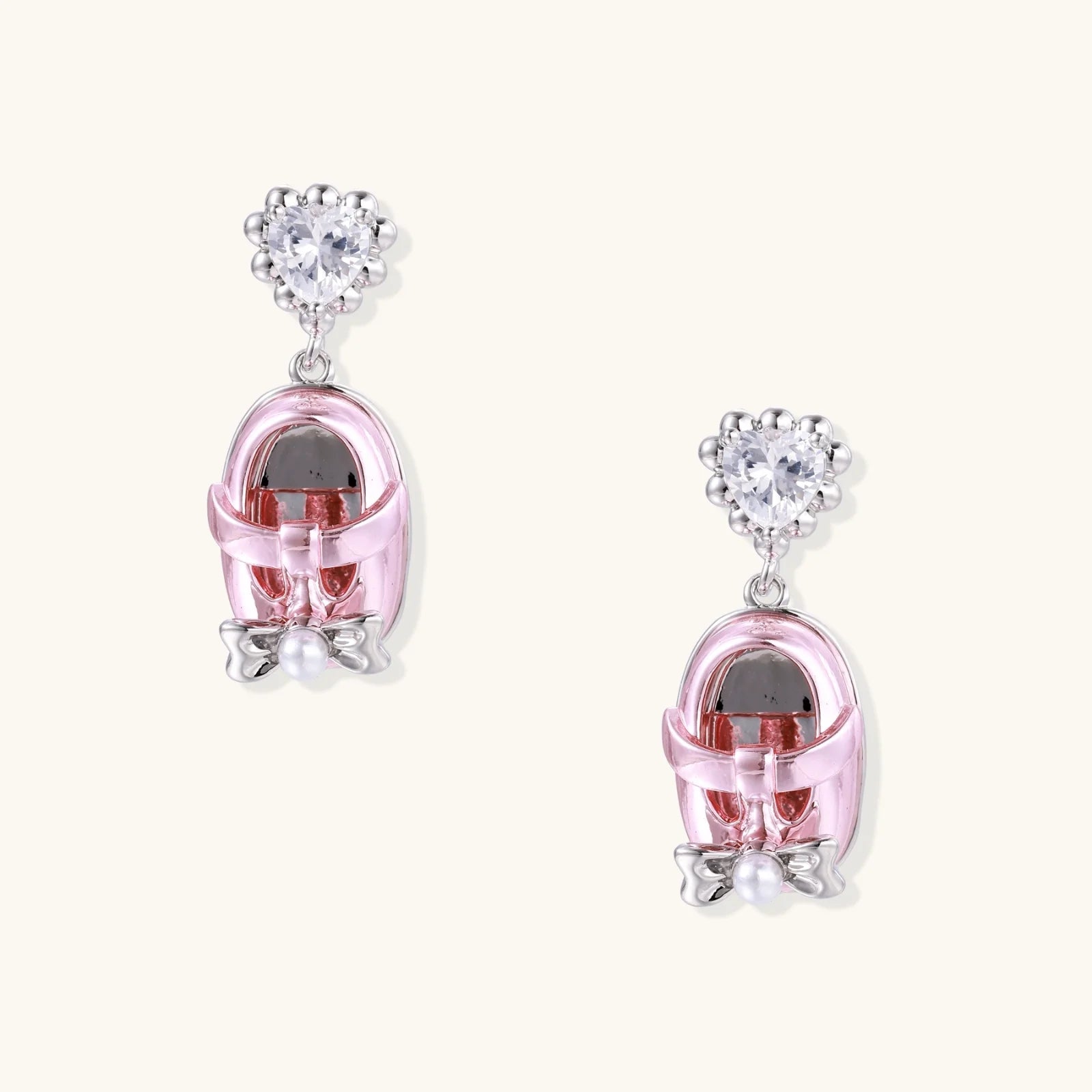 Drop earrings featuring miniature translucent handbag charms with heart crystal studs, silver bow accents, and pearls