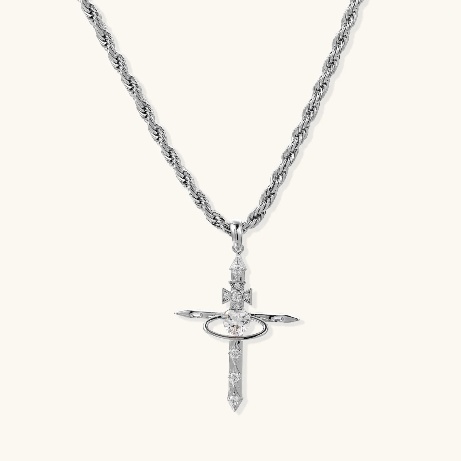 Silver-tone necklace with dimensional orb pendant, cross crown detail, and zirconia stones on twisted rope chain