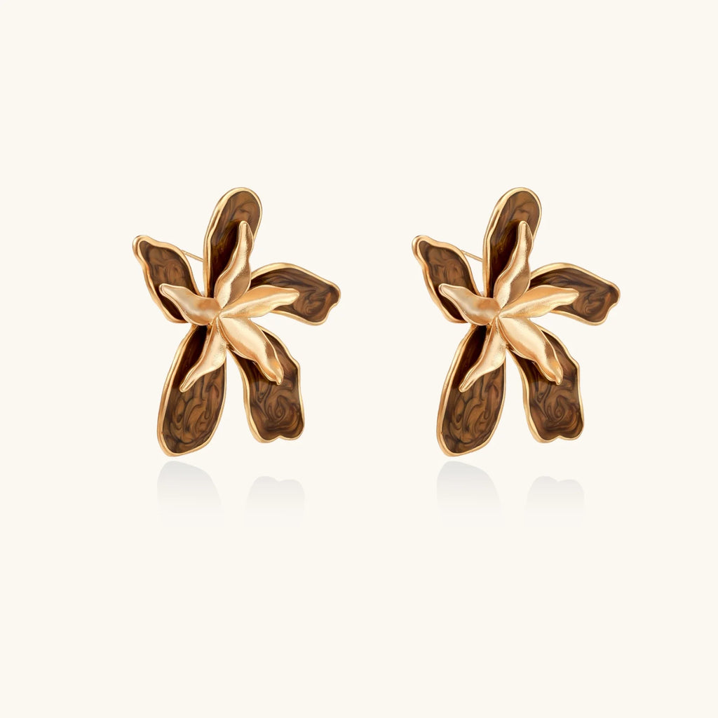 Gold-plated brass flower earrings with brown tortoiseshell enamel petals on cream background