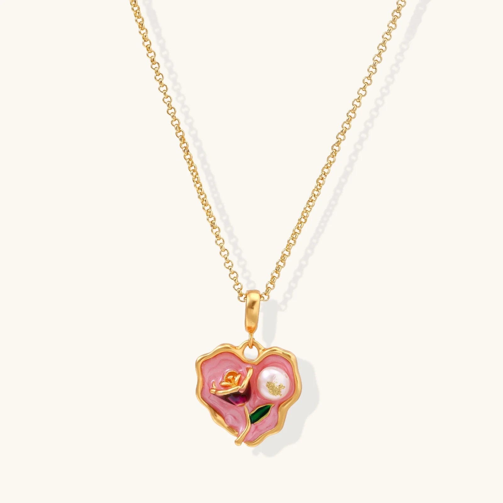 Heart-shaped pendant with pink enamel, rose design, freshwater pearl flower, and gold scalloped frame on delicate chain