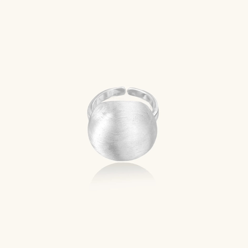 Minimalist brushed sterling silver dome ring with adjustable band on white background, front view.