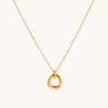 Delicate gold-plated necklace with three interlocking circle rings forming a minimalist knot pendant on cream background