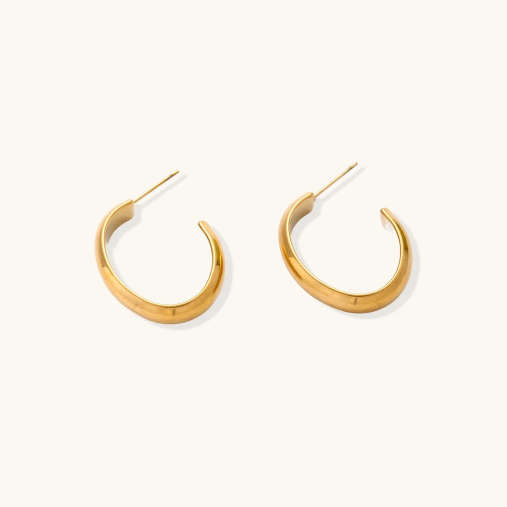 Chunky brushed gold hoop earrings in 14K plated stainless steel on cream background, front and side view.