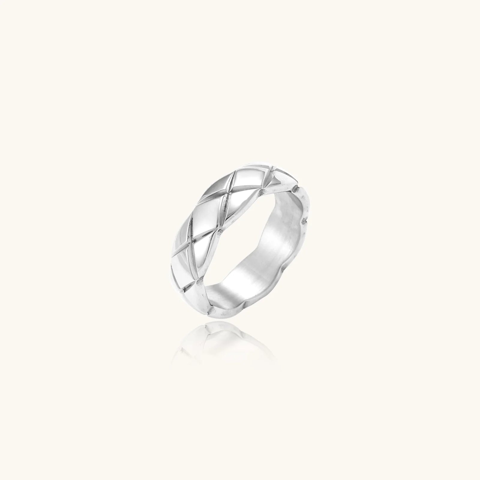 Braided stainless steel band ring with geometric interwoven strands in brushed silver finish on white background