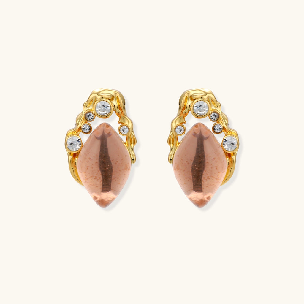 Gold-plated baroque stud earrings with coral-pink liuli stones and cubic zirconia crystals on white background.