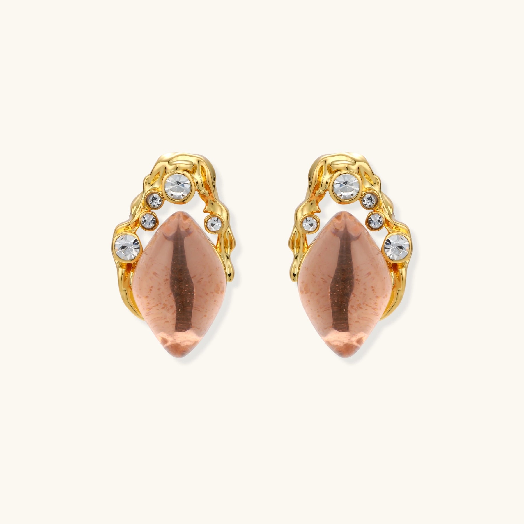 Gold-plated baroque stud earrings with coral-pink liuli stones and cubic zirconia crystals on white background.