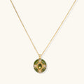 Gold-plated pendant necklace with green enamel background and oval olive cubic zirconia center stone with crystal accents.